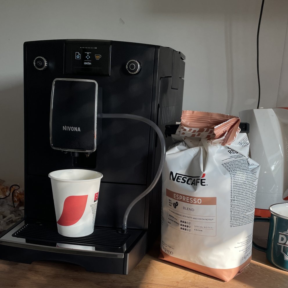 coffee maschine with paper cup and bag with coffee beans