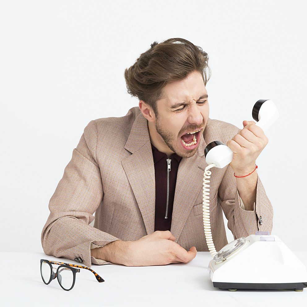 frustrated white man screaming into phone