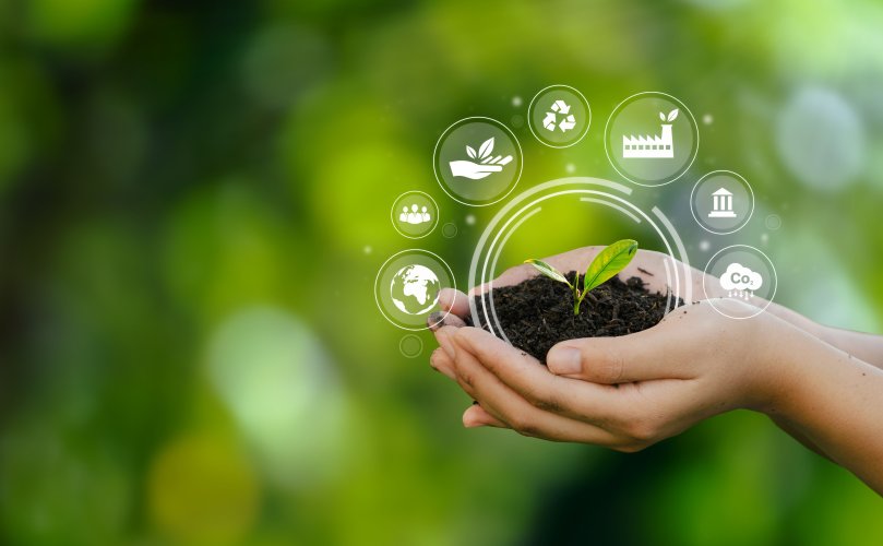hands holding soil with sustainability icons around it green background