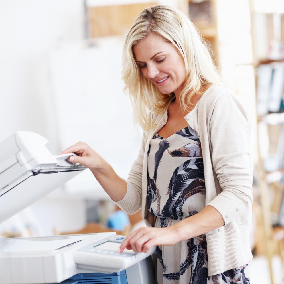 A woman is printing copies